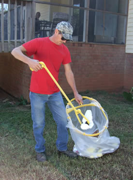 The Bag Mate reach extender helps you pick up trash.